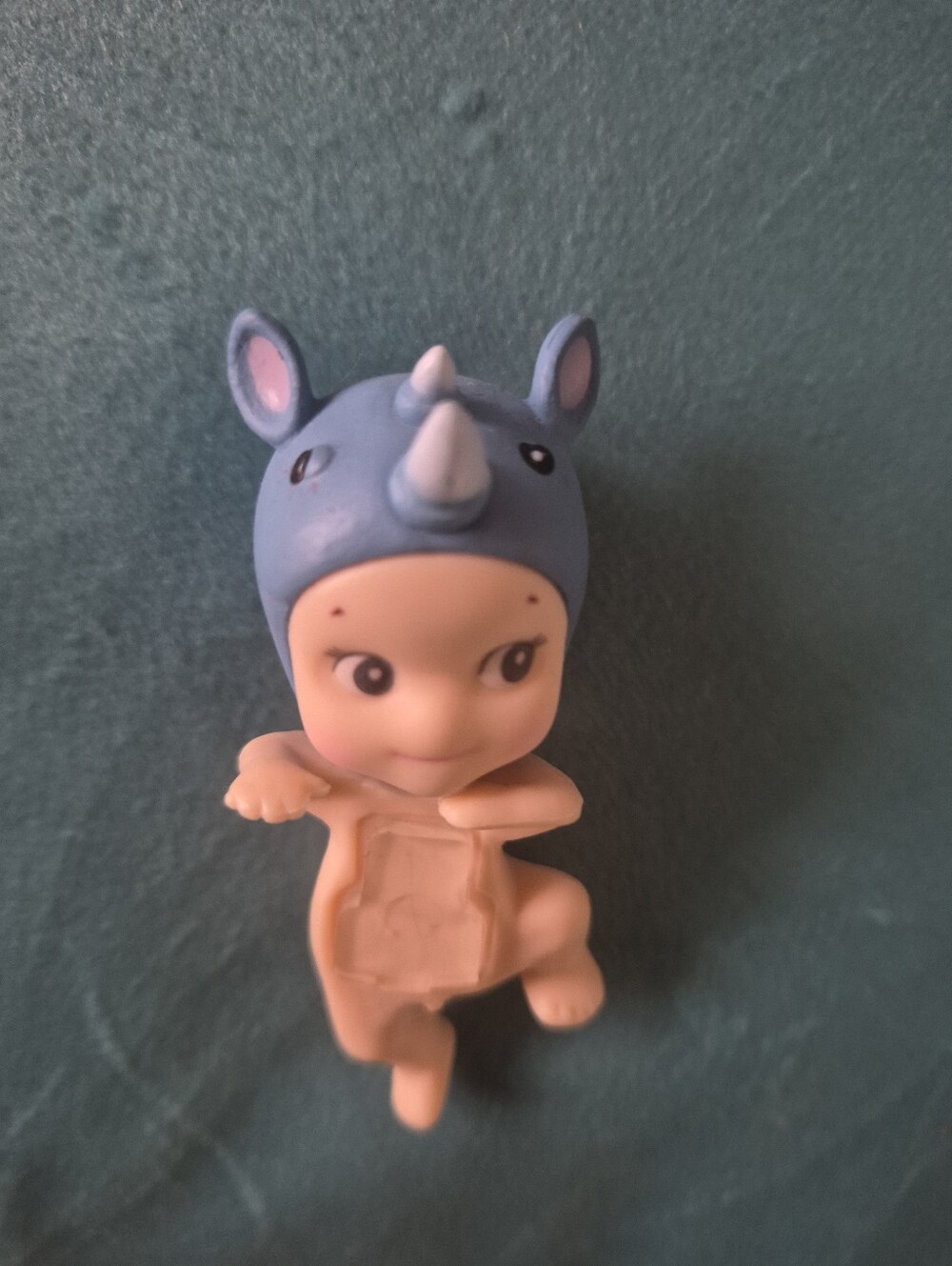 Baby Figurine Wearing Blue Rhino Hat